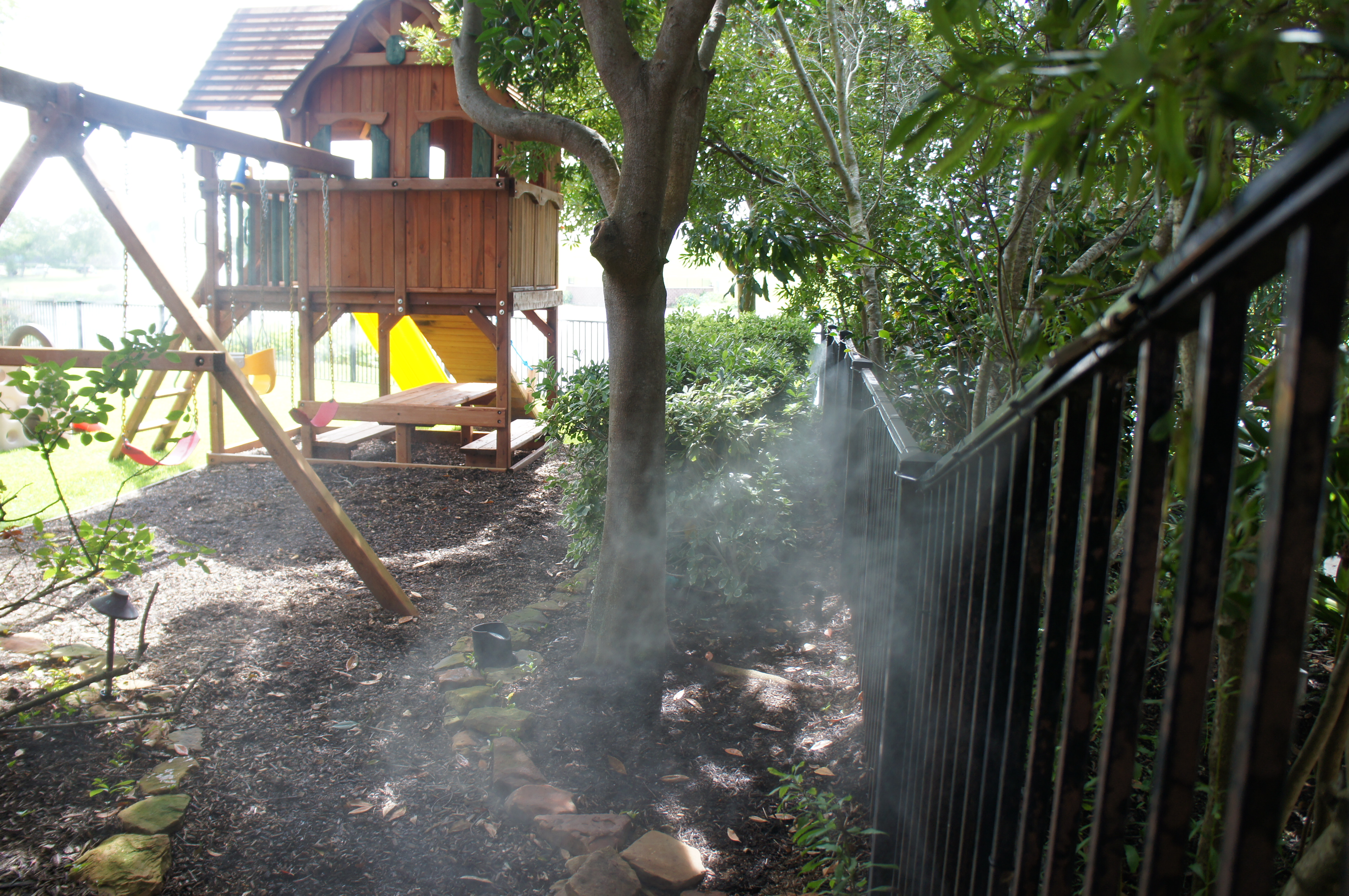 backyard with mosquito misting system backyard with mosquito misting system spraying fence